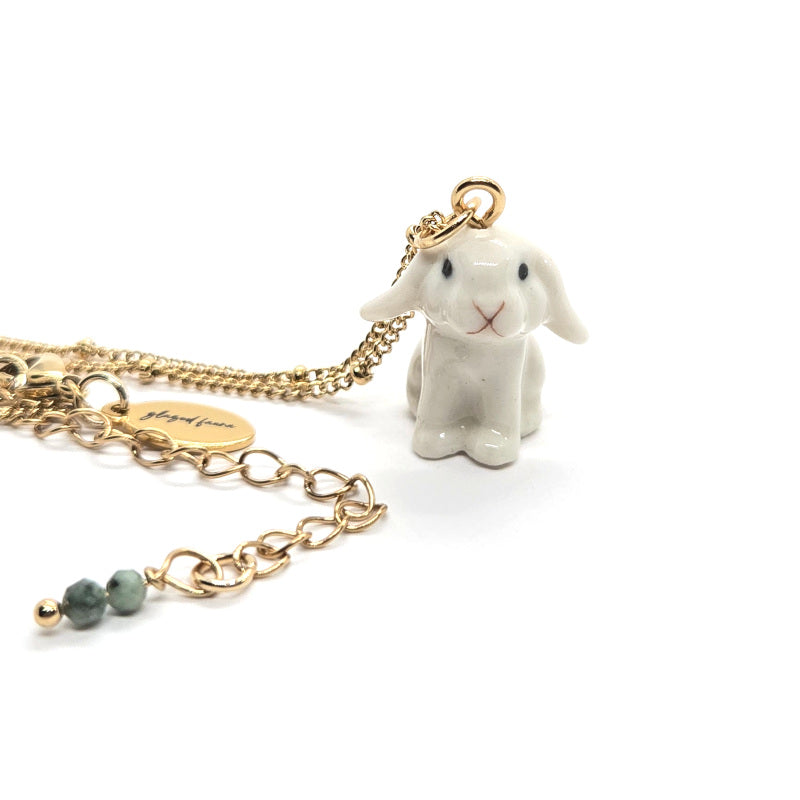 Ceramic white lop rabbit pendant attached to gold-plated beaded chain with Glazed Fauna tag.