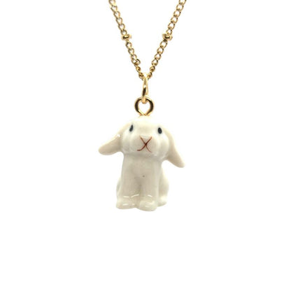 Ceramic white lop rabbit pendant attached to gold-plated beaded chain.