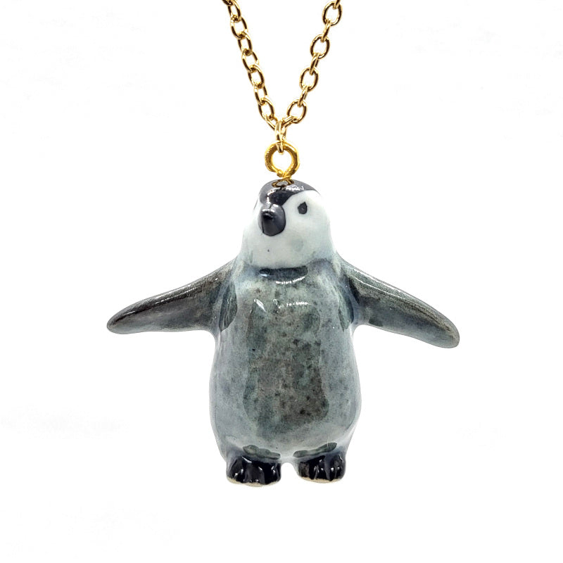 Baby penguins are adorable fluff balls of heartwarming cuteness! Start your ceramic animal jewellery collection with this adorable baby Emperor penguin, or get it as a gift for a special someone! Comes with a stainless steel or an 18K gold-plated cable chain. Penguin pendant is 3cm tall, 3.8cm long.